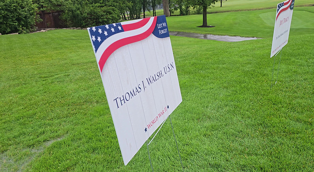 Signs at the 10th tee at Idlewild Country Club honoring veterans Thomas J. Walsh and Joe Tracy, part of the club's Memorial Day fundraising golf outing. (Eric Crump/H-F Chronicle)