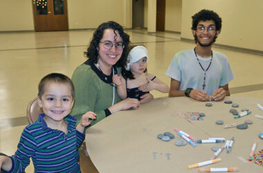 Members of the Cruz family paints rocks together during “The H-F Pebbles & Pins Project” at Flossmoor Community Church, where folks were invited to create uplifting messages to place around Homewood and Flossmoor. (Nuha Abdessalam/H-F Chronicle)