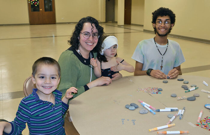 Pebbles and Pins#9_web Members of the Cruz family paints rocks together during “The H-F Pebbles & Pins Project” at Flossmoor Community Church, where folks were invited to create uplifting messages to place around Homewood and Flossmoor. (Nuha Abdessalam/H-F Chronicle)