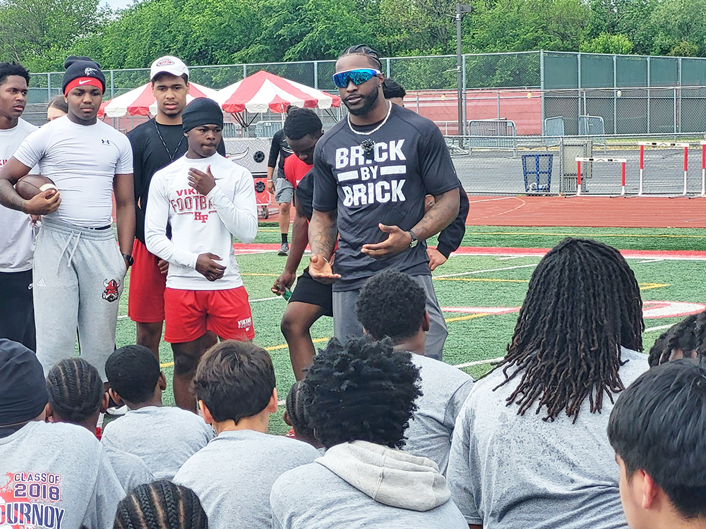 NFL wide reciever Ryan Flournoy speaks to young players at his youth football camp May 23 at his alma mater Homewood-Flossmoor High School. (David P. Funk/H-F Chronicle)