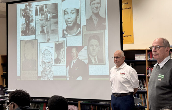 fvm-photo-6-manos-and-braun-at-parker_web Flossmoor Veterans Memorial Inc. directors Anthony (Tony) Manos (left) and retired Flossmoor mayor Paul Braun introduce 8th grade social studies students at Parker Junior High School to photos and biographies of area military veterans from the Homewood-Flossmoor area. (Karen Torme Olson)