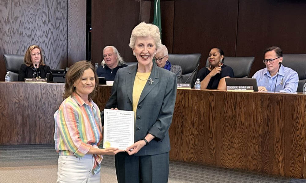 Flossmoor Mayor Michelle Nelson, left, presents a proclamation at the June 1 board meeting honoring her father, Richard Condon, on the occasion of his 95th birthday. (Jon Bannister/H-F Chronicle)