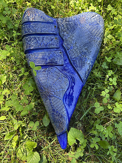 A blue, heart-shaped ceramic made by international artist Hilde DeBruyne is one of the items available in the Flossmoor Garden Art Auction. (Provided photo)