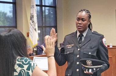 New Homewood police officer Lorielle Brown takes the oath of office, administered by Village Clerk Nakita Flores, during the May 26 Board of Trustees meeting. (Eric Crump/H-F Chronicle)