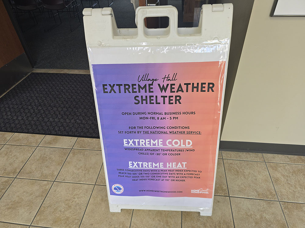 A sign in the hallway outside the Homewood village hall board room lets residents know the room can be used as a cooling shelter during days of extreme heat. (Eric Crump/H-F Chronicle)