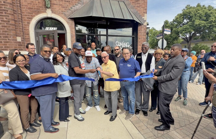 Homewood Mayor Rich Hofeld, right, holds the blue scissors with Old Fashioned Donuts Chicago owner Burritt L. Bullock, center and Old Fashion Donuts Homewood owner Joe Peters, as they cut the blue ribbon to open the new donut shop. (Nick Ulanowski / H-F Chronicle)