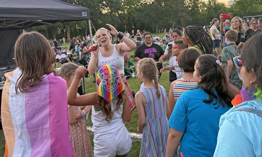 Beyond the Blonde singer Charity Marie walks through the crowd as she sings “Pink Pony Club” by Chapel Roan with attendees. (Nick Ulanowski / H-F Chronicle)
