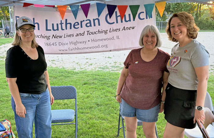 Courtney Suchor, left, Katrina Perez and Emily Kramer, right, operate the Faith Lutheran Church booth at Pride Fest 2026. (Nick Ulanowski / H-F Chronicle)