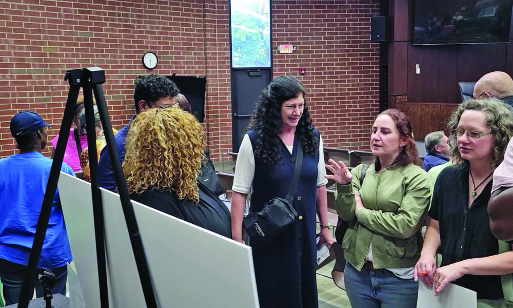 Lori Tozer, center, Liz Varmecky and Hilary Pries, right, discuss ideas for a park that could replace the Flossmoor south commuter lot. (Eric Crump/H-F Chronicle)