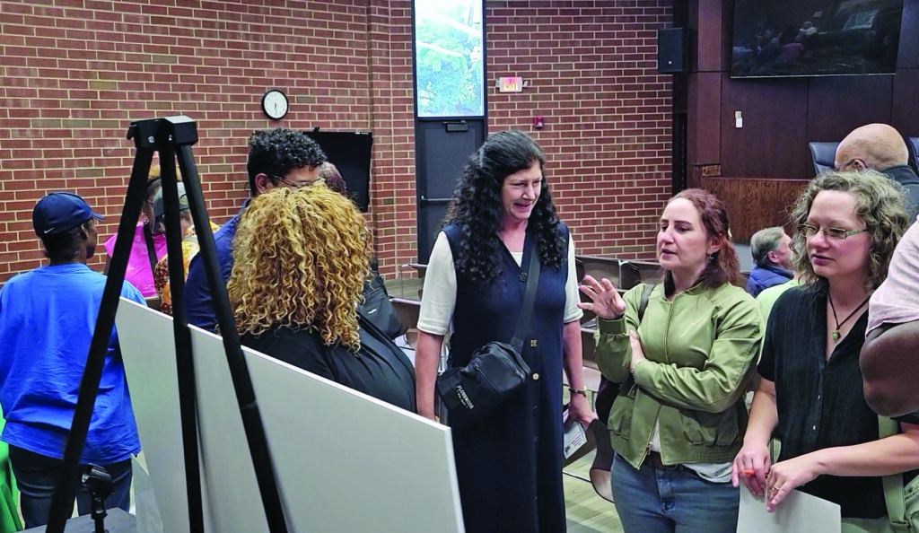 Lori Tozer, center, Liz Varmecky and Hilary Pries, right, discuss ideas for a park that could replace the Flossmoor south commuter lot. (Eric Crump/H-F Chronicle)