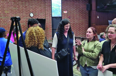 Lori Tozer, center, Liz Varmecky and Hilary Pries, right, discuss ideas for a park that could replace the Flossmoor south commuter lot. (Eric Crump/H-F Chronicle)