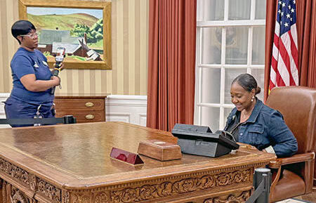 A replica of President Barack Obama’s Oval Office in the West Wing of the White House is one of the Center’s most popular attractions so far. Docents are on hand at the display to take photos of visitors like Dawn Edwards of South Holland, who took the opportunity to try out the Resolute Desk. (Karen Torme Olson/H-F Chronicle)