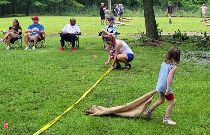 A youngster hauls a sack across the field at the Izaak Walton community picnic on July 4. The event featured a number of old-fashioned games. (Eric Crump/H-F Chronicle)