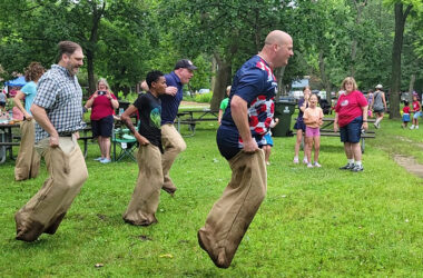 Adults take a turn at the one-legged race during the Izaak Walton community picnic on July 4. (Eric Crump/H-F Chronicle)