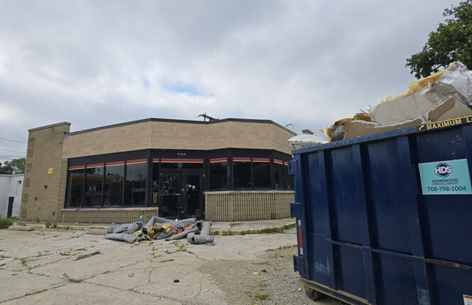 A dumpster parked at the former Citgo gas station on 183rd Street on Saturday, July 25, indicates cleanup has begun in preparation for redeveloping the building. (Eric Crump/H-F Chronicle)