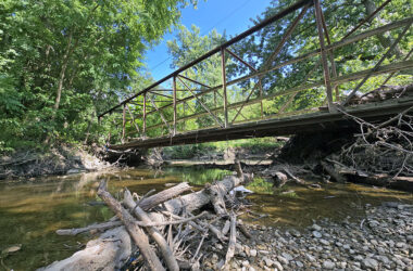 Dartmouth Pedestrian Bridge spans the now placid Butterfield Creek. Storms in June and July, however, produced flooding that pummeled the bridge, damaging its deck. (Eric Crump/H-F Chronicle)