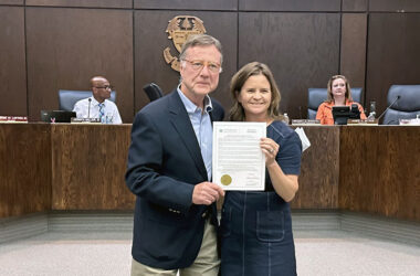 Flossmoor Station Restaurant & Brewery co-owner Dean Armstrong, left, accepts a resolution from Mayor Michelle Nelson honoring the business for 30 years of service to the community. (Jon Bannister/H-F Chronicle)