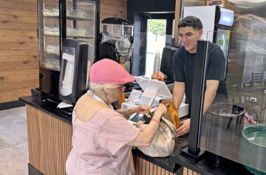 Fil-a-Pita owner Soltan Frehat hands a free pita to a customer during the restaurant's opening day Friday, July 17. (Jon Bannister/H-F Chronicle)
