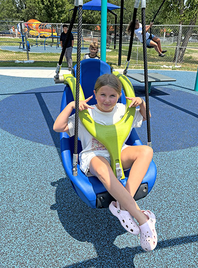 Chloe Calderone,9, tries out one of the new swings that is on a zipline track at Irwin Park playground. (Marilyn Thomas/H-F Chronicle)