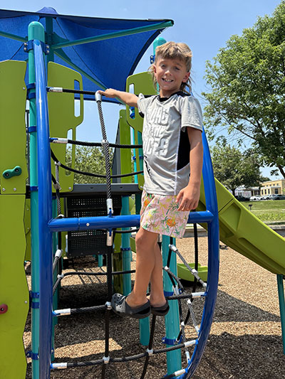 Jaxon Calderone, 8, was getting to new heights on the climbing apparatus at Irwin Park. (Marilyn Thomas/H-F Chronicle)