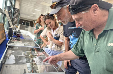 Joe Flens, right, shows Flossmooor Mayor Michelle Nelson, second from right, his collection of electric line memorabilia from his career working for what is now Metra. (Jon Bannister/H-F Chronicle)