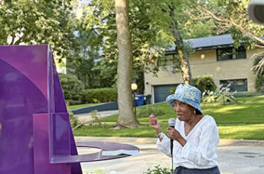 Leona Calvin of the Flossmoor Art Commission discusses a rotating piece "Sans Titre Ref 366" during the sculpture walk on July 8. (Stephanie Sokol/H-F Chronicle)