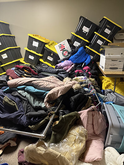Rows of donated winter coats and storage bins were damaged when flooding filled the basement at Suburban Access Outreach. (Provided photo/Suburban Access Outreach)