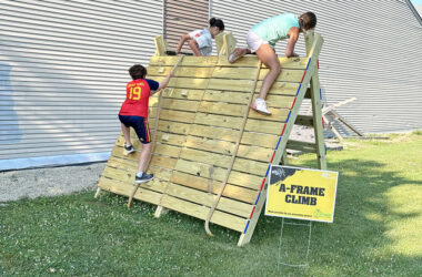 The Beast obstacle course has these three runners climbing over the A-Frame. (Marilyn Thomas/H-F Chronicle)