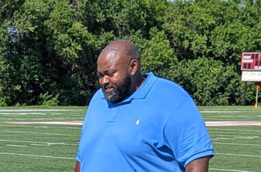 Coach Walter Collins Jr. walks the sidelines during his flag football team's summer camp. (David P. Funk/H-F Chronicle)