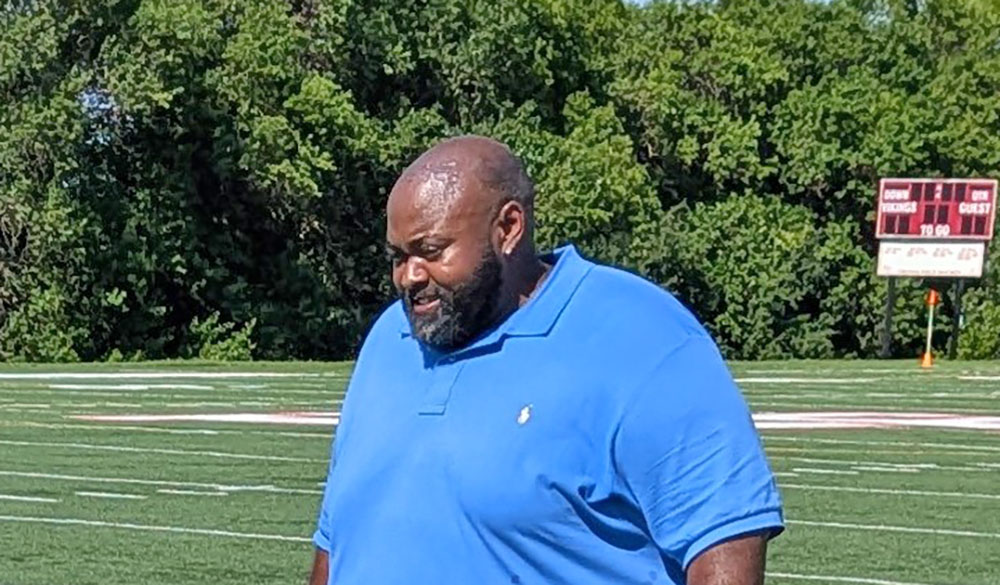 Coach Walter Collins Jr. walks the sidelines during his flag football team's summer camp. (David P. Funk/H-F Chronicle)