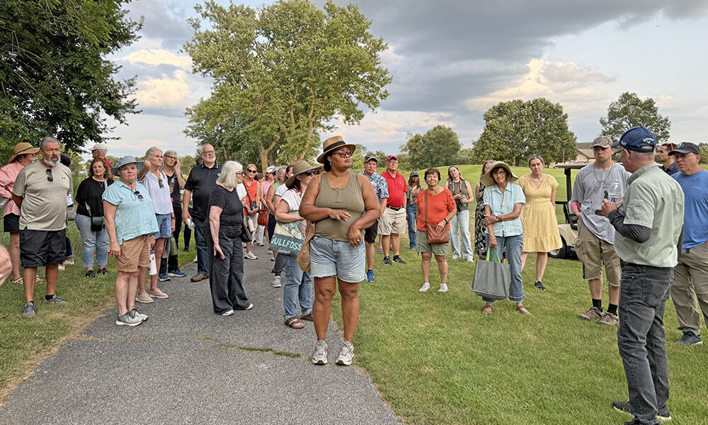 Dave Ward, in the blue cap far right, speaks to a group of people on his annual nature walk at Coyote Run Golf Course. (Stephanie Sokol/H-F Chronicle)