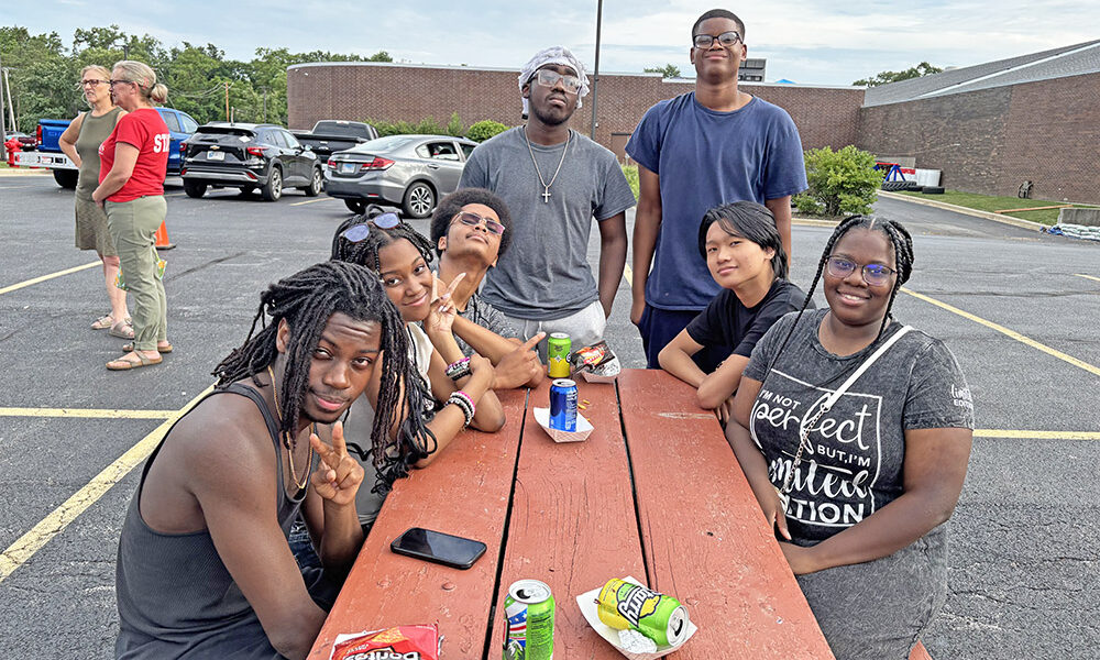 Homewood-Flossmoor High School friends, from left, Marcus Conner, Maddie Nelson, Terrance Rainey, Martin Guest, Jacari Freeman, James Yast and Lula Pollard, gathered around the picnic table. (Marilyn Thomas/H-F Chronicle)